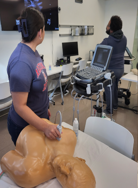 Student performing ultrasound on mannequin